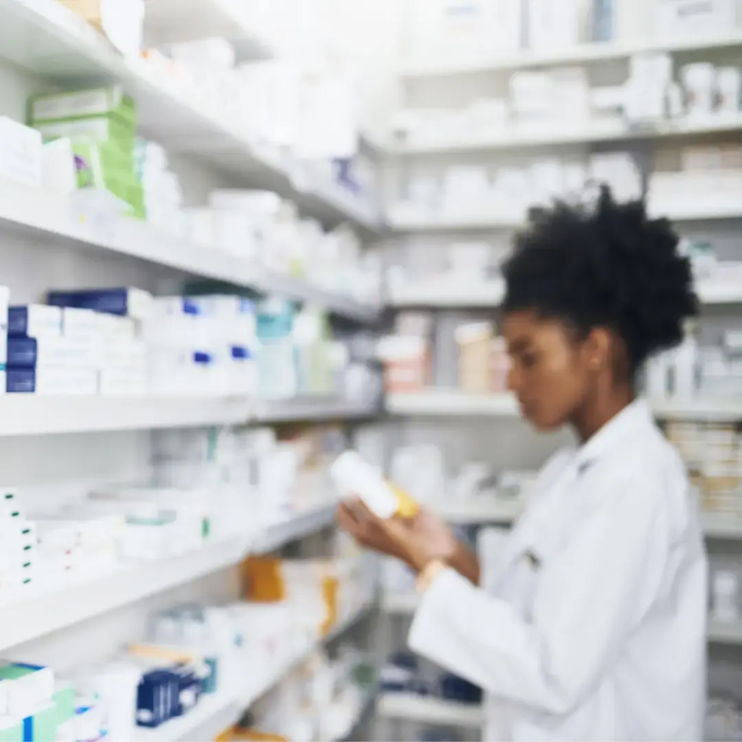 Woman checking out bottles in a pharmacy