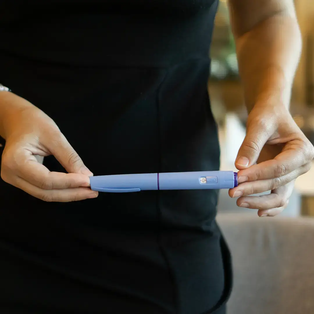 Patient holding a GLP-1 Injector